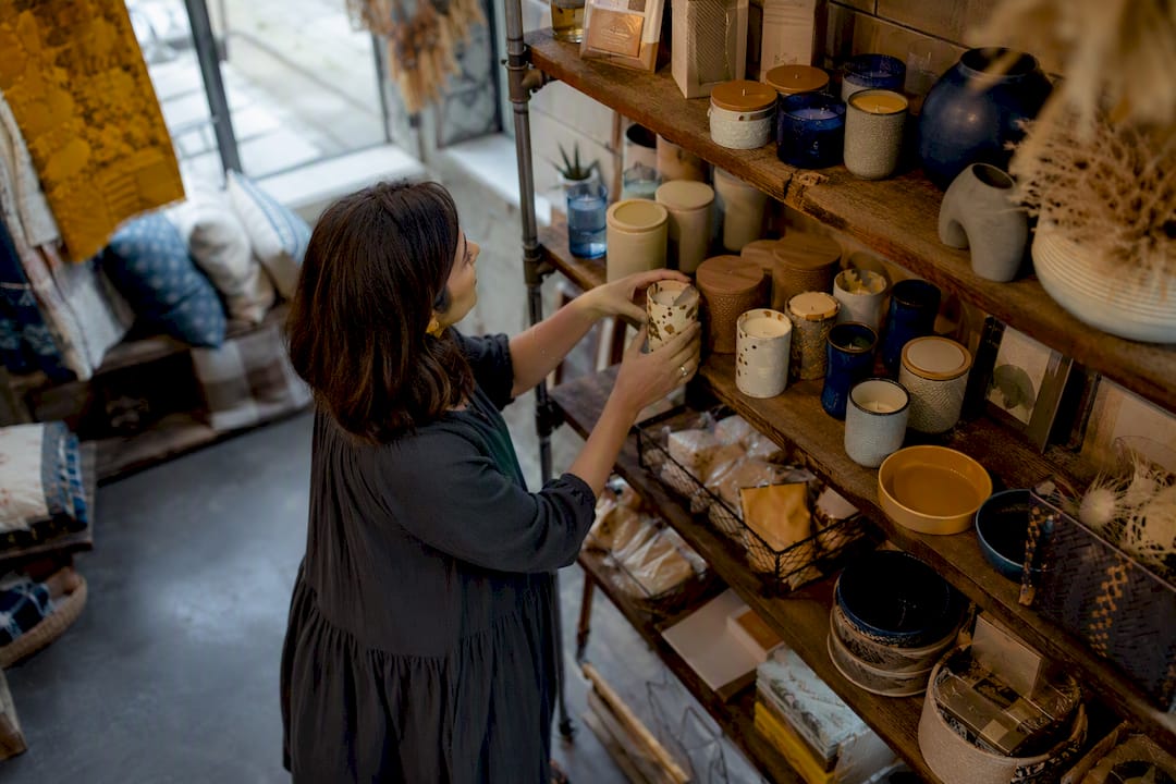 Hands placing impulse-buy product in store
