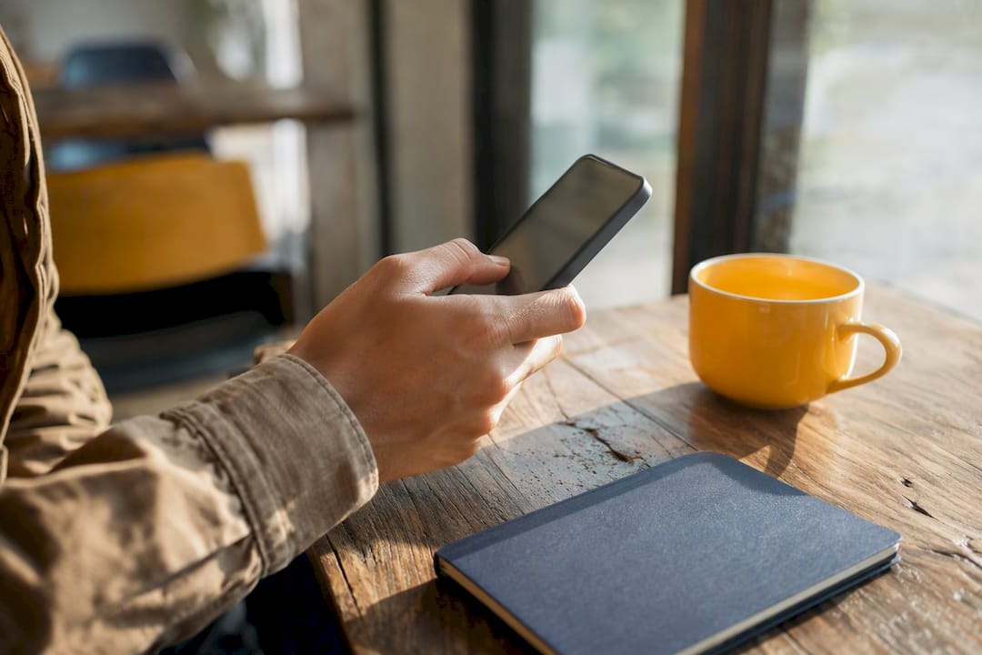 Hands using smartphone with thumb