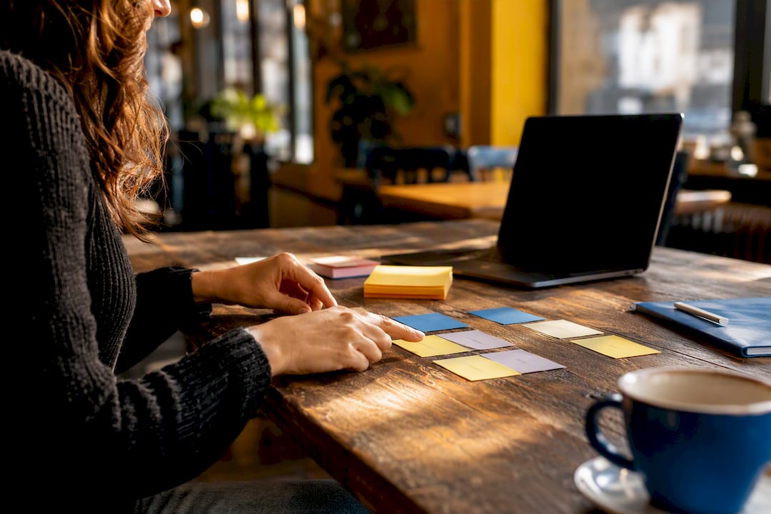 Hands arranging marketing automation task cards
