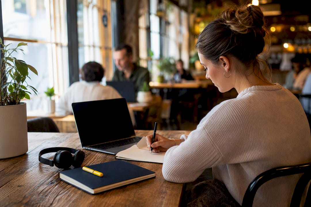 Envision Marketing Agency | MQL vs. SQL: The Difference That Decides Your Pipeline Headset and notes on call workspace desk